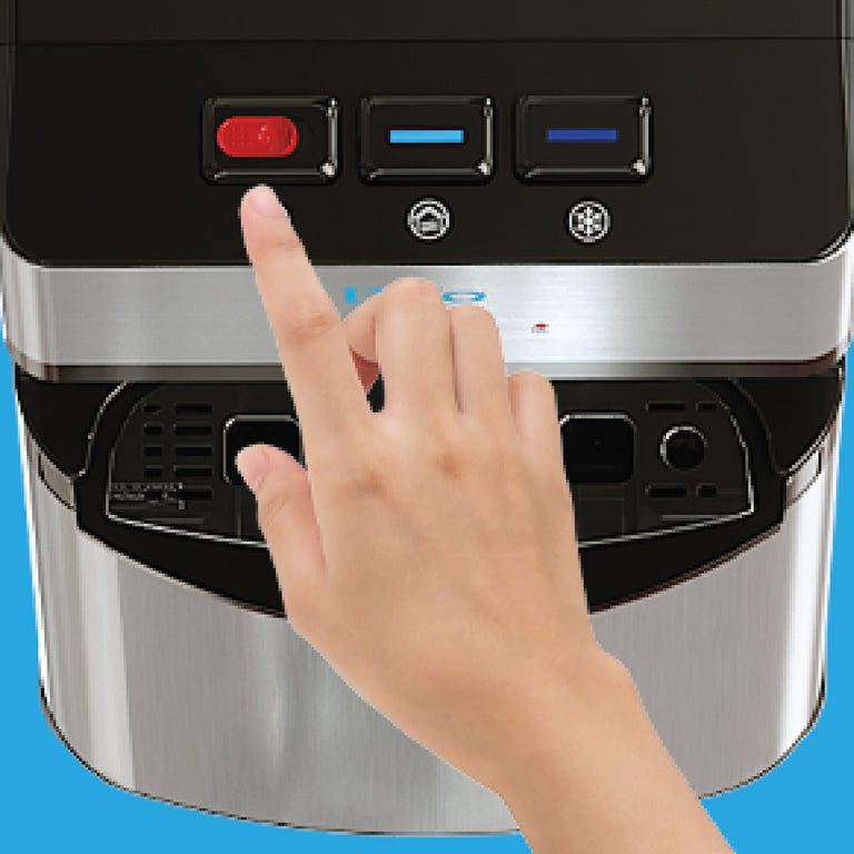 A hand with an extended index finger is about to press the red power button on the control panel of a stainless steel appliance, possibly an ice maker or water dispenser.